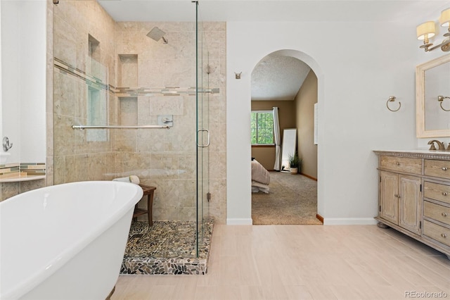 20922 E Crestline Cir, Centennial, CO 80015 - bathroom featuring a stall shower, a freestanding bath, vanity, and baseboards