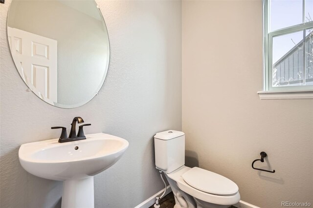 1715 Pioneer Cir, Lafayette, CO 80026 - half bathroom with toilet, baseboards, and a sink