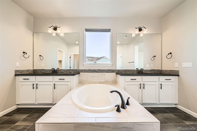 1715 Pioneer Cir, Lafayette, CO 80026 - bathroom with baseboards, a bath, and two vanities