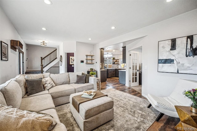 living room with dark wood-type flooring, stairway, and recessed lighting