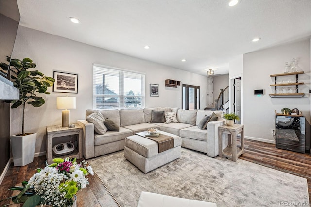 living area with stairs, baseboards, wood finished floors, and recessed lighting