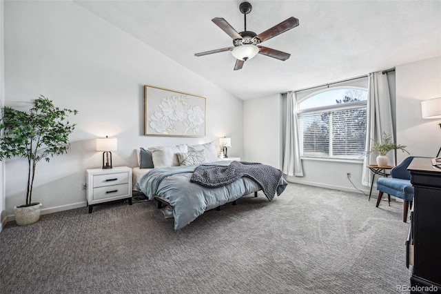 bedroom with baseboards, dark carpet, vaulted ceiling, and a ceiling fan