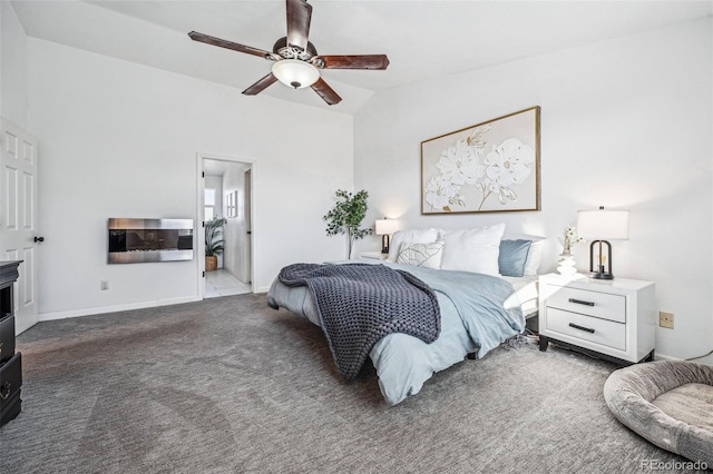 bedroom featuring lofted ceiling, dark colored carpet, a ceiling fan, and baseboards