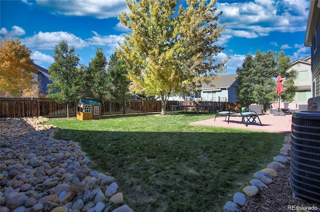 view of yard with central air condition unit, a patio area, and a fenced backyard