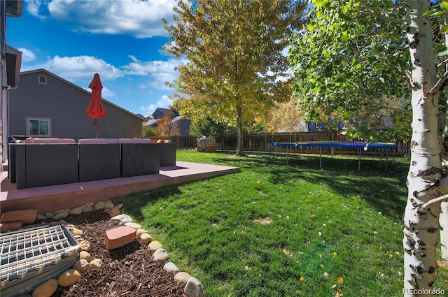 view of yard featuring a fenced backyard, a trampoline, and a patio