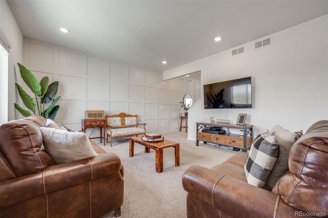 living room with light carpet and recessed lighting