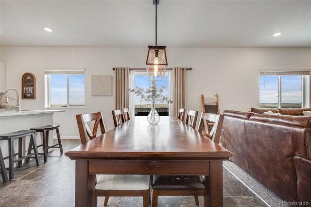 dining space with plenty of natural light, recessed lighting, and baseboards