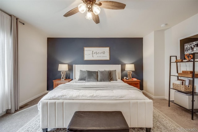 bedroom featuring light carpet, baseboards, and ceiling fan