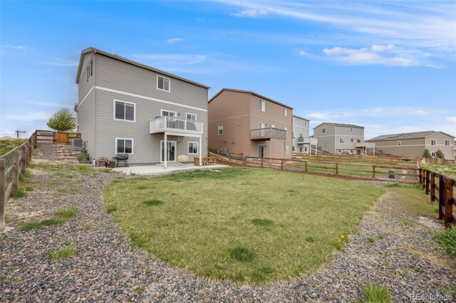 rear view of property featuring a patio and a balcony