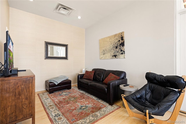 living room with visible vents, wood finished floors, and recessed lighting