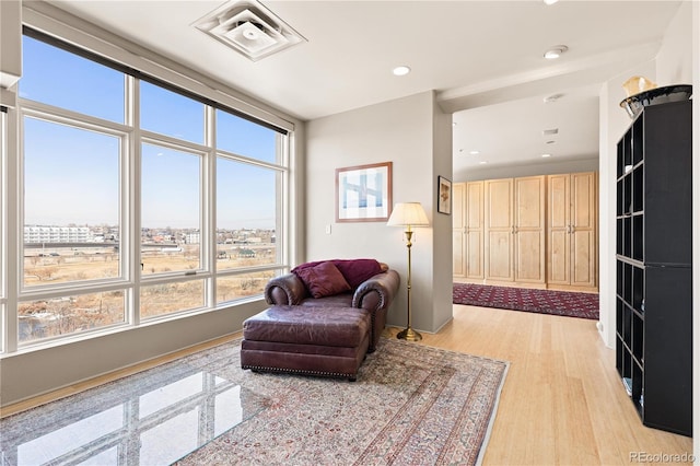 sitting room featuring recessed lighting, visible vents, and light wood-style floors