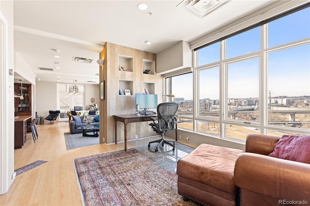 home office with light wood-style flooring, visible vents, and recessed lighting