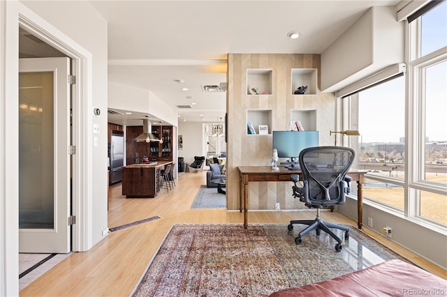 office space featuring light wood-style flooring and recessed lighting