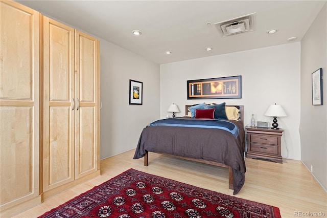 bedroom with recessed lighting, visible vents, and light wood finished floors