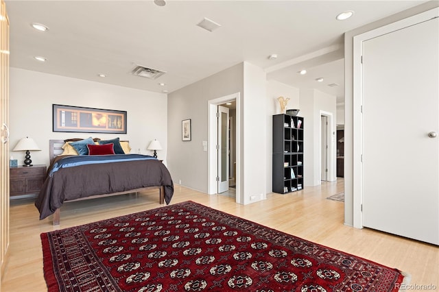 bedroom with light wood-type flooring, visible vents, and recessed lighting