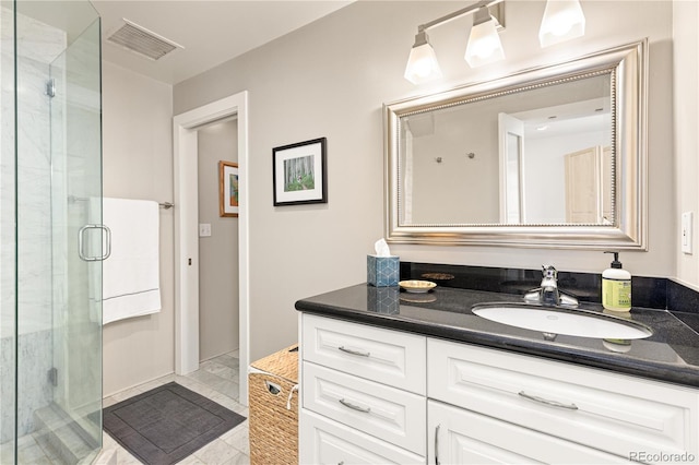 full bathroom with a shower stall, visible vents, and vanity