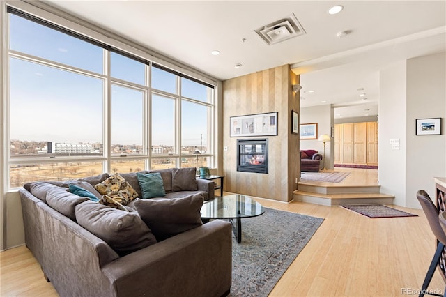 2000 Little Raven St Unit 501, Denver, CO 80202 - living area with a large fireplace, light wood-style floors, visible vents, and recessed lighting
