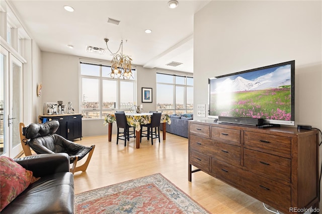 2000 Little Raven St Unit 501, Denver, CO 80202 - living area with light wood finished floors, visible vents, and a chandelier