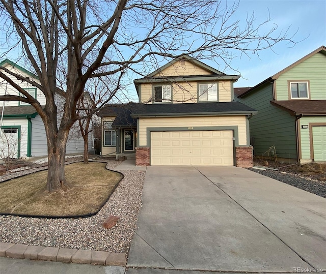 view of front of house with a garage, brick siding, and driveway