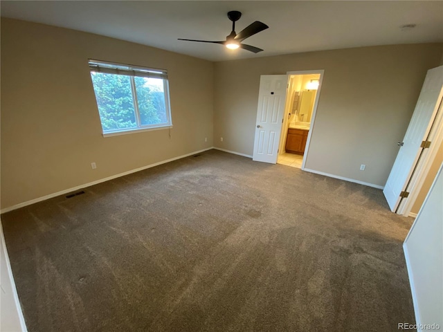 unfurnished bedroom with ensuite bathroom, baseboards, visible vents, and carpet floors