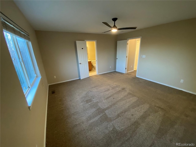 unfurnished bedroom with visible vents, connected bathroom, baseboards, carpet flooring, and a ceiling fan