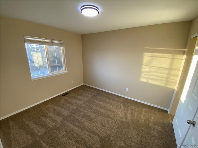 unfurnished bedroom with visible vents, carpet floors, and baseboards