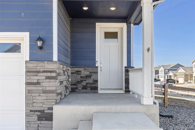 view of exterior entry with a garage