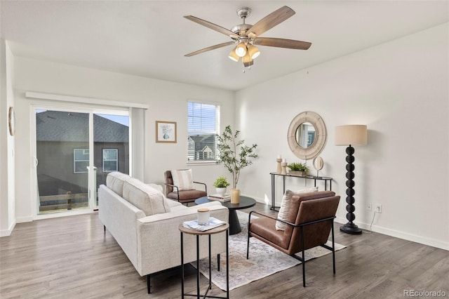 living room with dark hardwood / wood-style flooring and ceiling fan