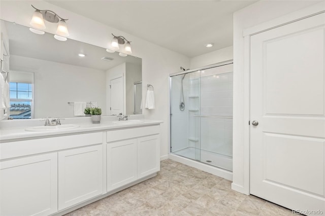 bathroom featuring vanity and a shower with shower door