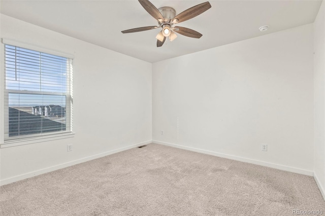 empty room with ceiling fan and light colored carpet