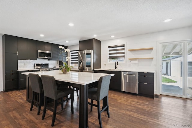 9563 W Caley Ave, Littleton, CO 80123 - dining space with dark wood-style flooring, a textured ceiling, wet bar, and recessed lighting