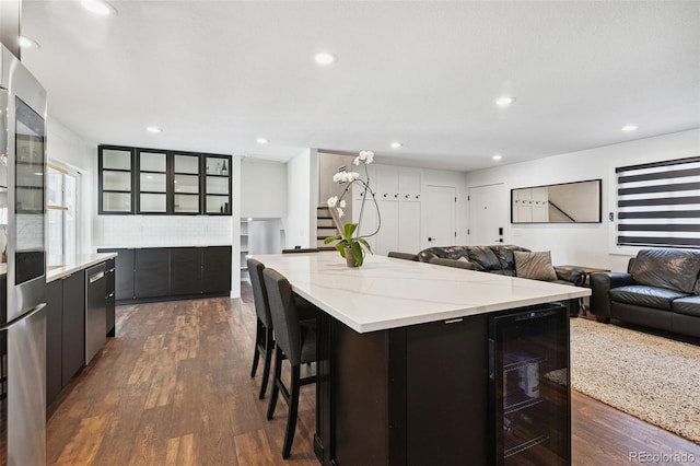 9563 W Caley Ave, Littleton, CO 80123 - kitchen featuring wine cooler, dark wood-style floors, open floor plan, a large island, and recessed lighting