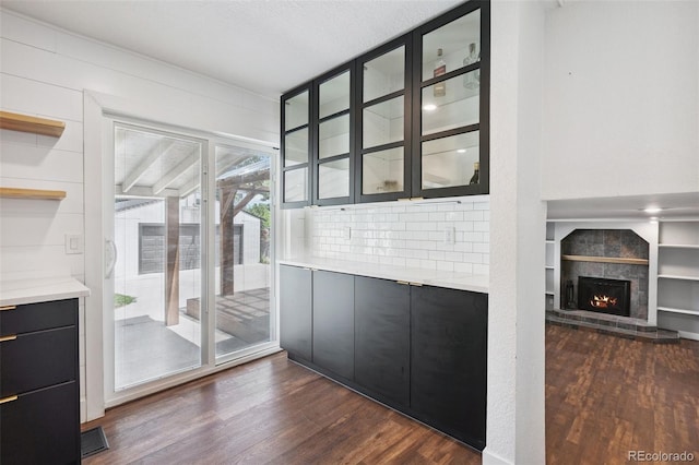 9563 W Caley Ave, Littleton, CO 80123 - unfurnished dining area featuring dark wood-type flooring and a fireplace