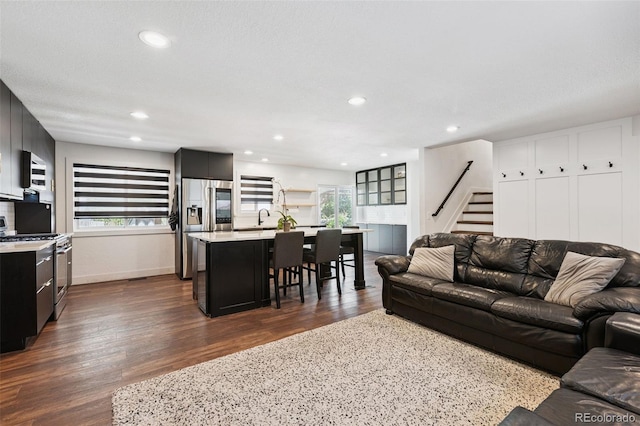 9563 W Caley Ave, Littleton, CO 80123 - living room with healthy amount of natural light, stairs, dark wood-type flooring, and recessed lighting