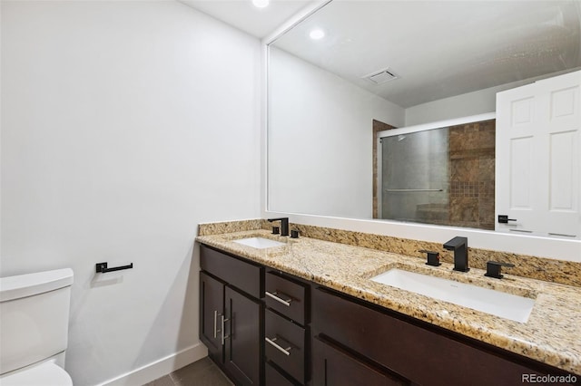9563 W Caley Ave, Littleton, CO 80123 - bathroom with double vanity, a shower stall, and recessed lighting