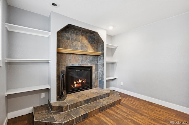 9563 W Caley Ave, Littleton, CO 80123 - detailed view of a tile fireplace and wood finished floors
