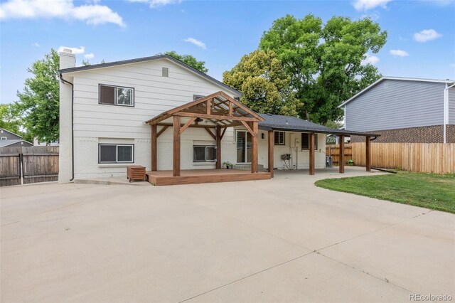 9563 W Caley Ave, Littleton, CO 80123 - rear view of house with brick siding, a chimney, and a patio area