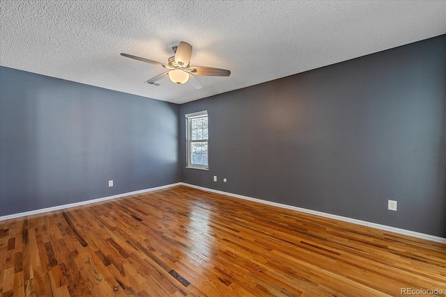 unfurnished room with ceiling fan, a textured ceiling, and hardwood / wood-style flooring