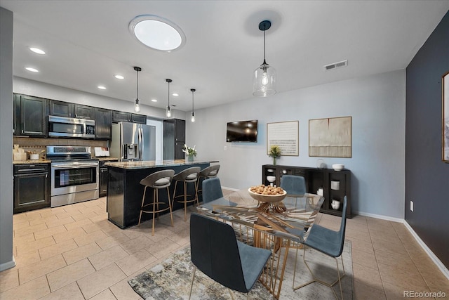 dining area featuring light tile patterned floors, baseboards, visible vents, and recessed lighting