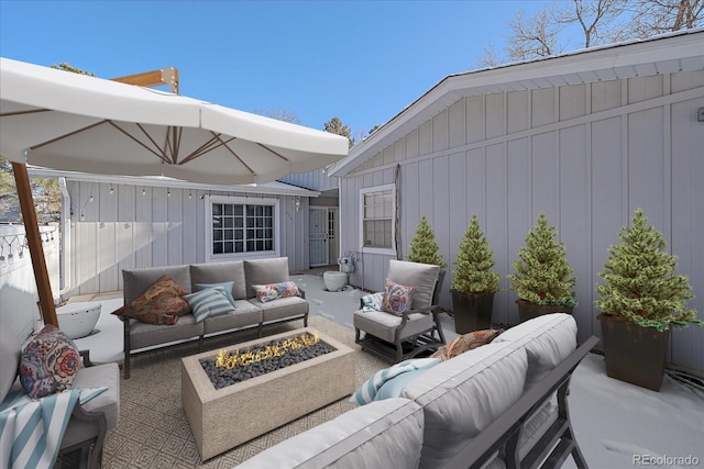 view of patio / terrace with an outdoor living space with a fire pit