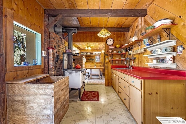 8929 Apache Dr, Beulah, CO 81023 - kitchen with wooden walls, a wooden ceiling with exposed beams, open shelves, light floors, and a wood stove