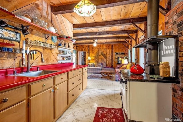 8929 Apache Dr, Beulah, CO 81023 - kitchen with wooden walls, a wood ceiling with exposed beams, light flooring, and dark countertops