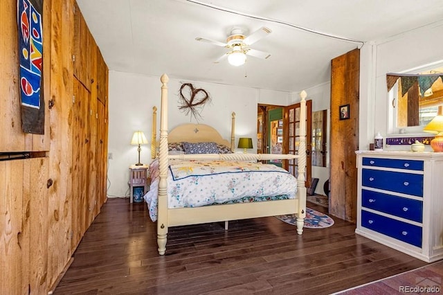 8929 Apache Dr, Beulah, CO 81023 - bedroom featuring wood finished floors, wood walls, and ceiling fan