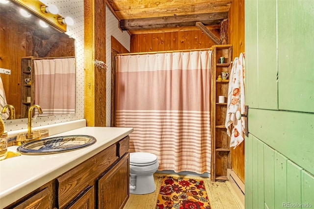 8929 Apache Dr, Beulah, CO 81023 - full bathroom featuring hardwood / wood-style floors, vanity, wooden walls, and a baseboard radiator