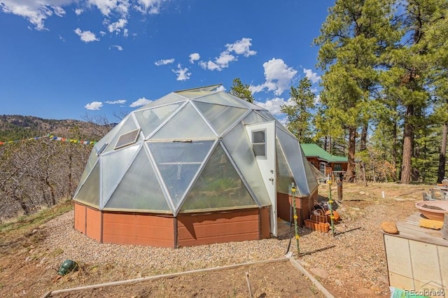 8929 Apache Dr, Beulah, CO 81023 - view of side of property featuring a greenhouse and an outbuilding