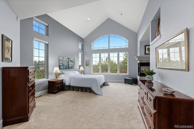 5171 Shade Tree Ln, Parker, CO 80134 - bedroom featuring multiple windows, high vaulted ceiling, light colored carpet, and a glass covered fireplace