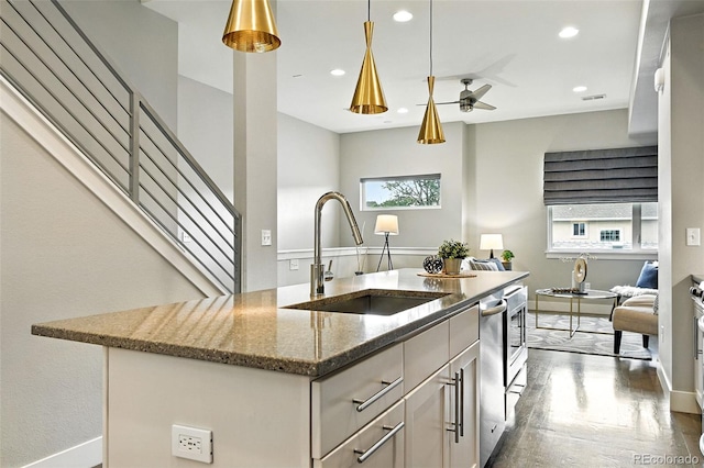 3431 W 16th Ave, Denver, CO 80204 - kitchen featuring light stone countertops, wood finished floors, a ceiling fan, hanging light fixtures, and recessed lighting