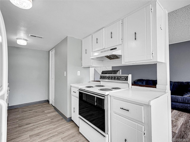 kitchen with under cabinet range hood, visible vents, white cabinetry, white range with electric cooktop, and light wood-type flooring