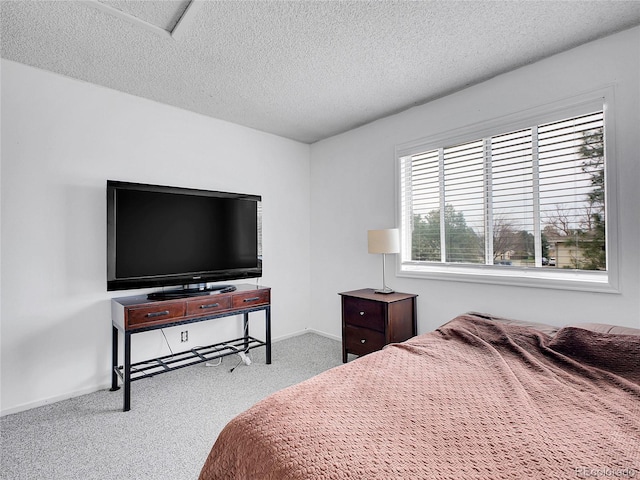 bedroom featuring a textured ceiling and carpet floors