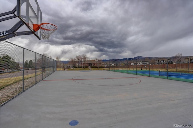 view of basketball court featuring fence and community basketball court